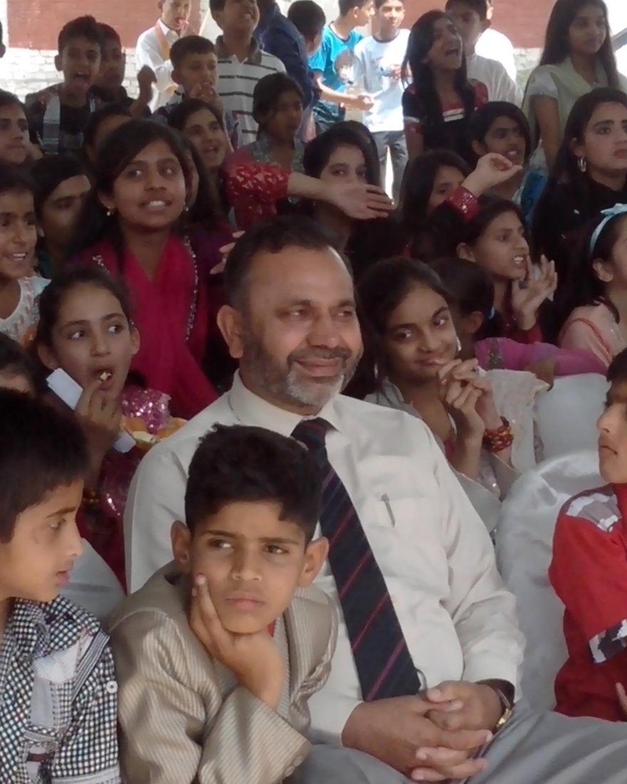 Col (Retd) Atta Rasool Malik seated among a large group of his students